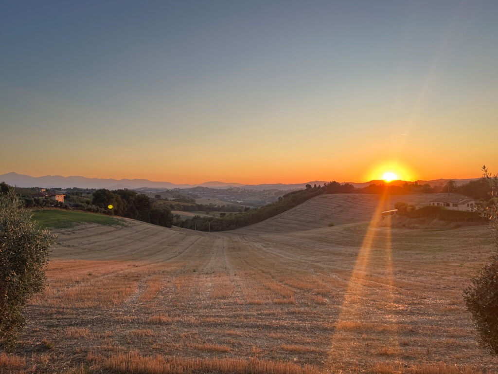 orange sunset in the countryside, le marche italy 