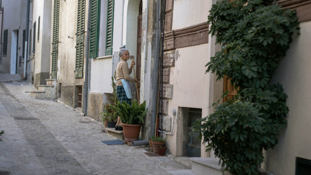 Person outside a door in an old town in Italy 