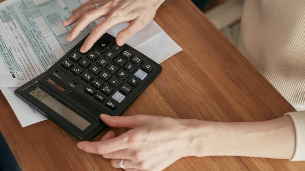 Calculator and utility bills on a desk 